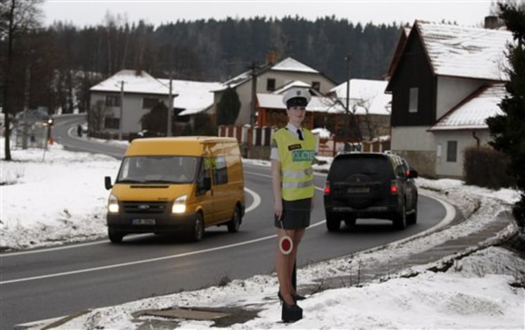 A cardboard police women officer in a mini skirt is displayed to slow down traffic in the village of Myslotin, central Czech Republic on Thursday.